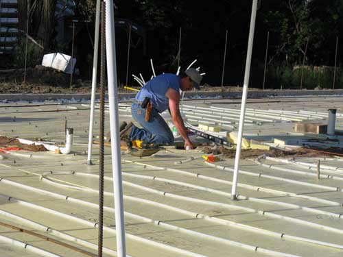 Husband laying the in-floor tubes for heating the house.