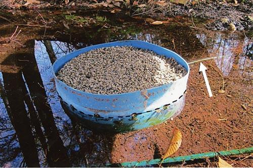 The gravel pre-filter in the spring. Pipe to the collection barrel (see arrow) = Water level