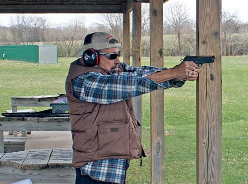 Practice shooting from behind cover. Here, the author is using the support beam to replicate the corner of a heavy wall.