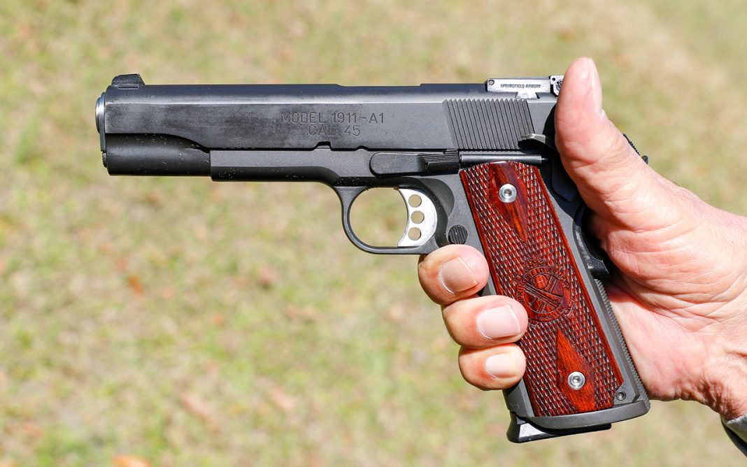 A 1911 pistol in hand