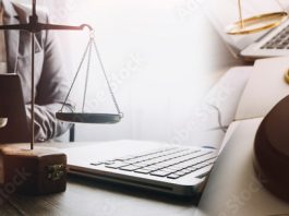 Justice and law concept. Gavel on sounding block in hand's Male judge at a courtroom, working with document law books, report the case on table in modern office.