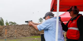 Master shooter Steve Sager double taps a target. Two spent casings in air, gun still level show speed and skill.