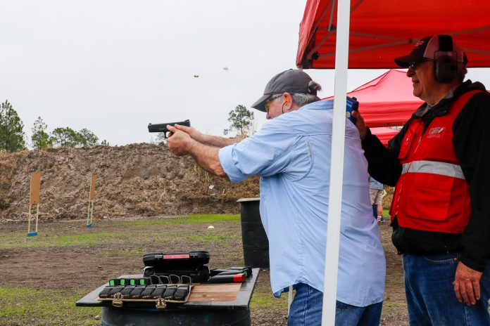 GSSF02_22_02 Master shooter Steve Sager double taps a target. Two spent casings in air, gun still level show speed and skill.